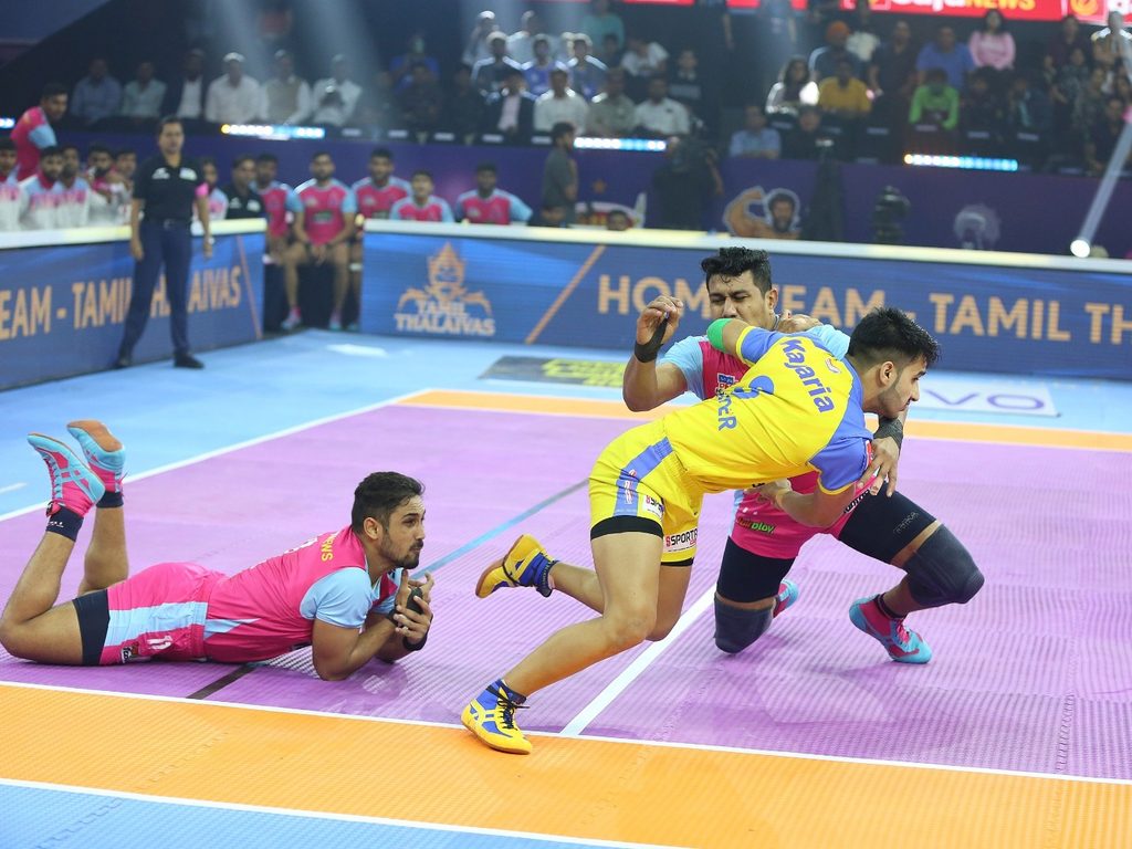 Tamil Thalaivas' K. Prapanjan, in blue and yellow jersey, is pinned down by  players of Patna Pirates during their Vivo Pro Kabaddi league match in  Mumbai, India, Saturday, Aug. 26, 2017. (AP