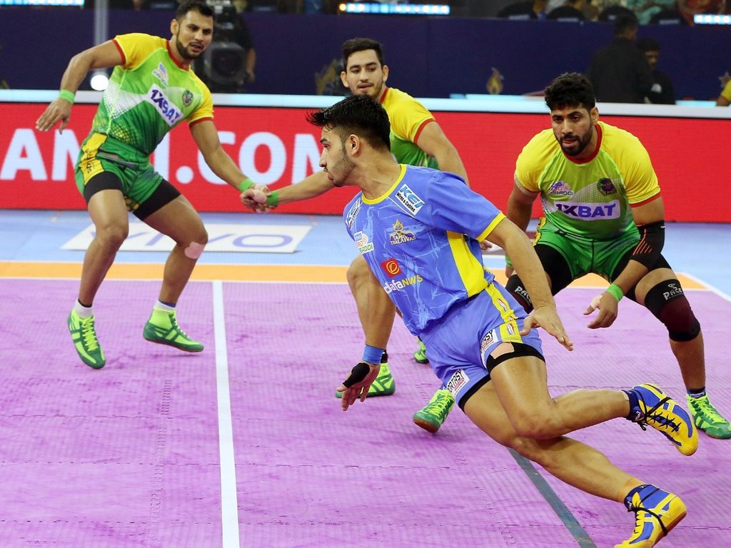 Tamil Thalaivas' K. Prapanjan, in blue and yellow jersey, is pinned down by  players of Patna Pirates during their Vivo Pro Kabaddi league match in  Mumbai, India, Saturday, Aug. 26, 2017. (AP